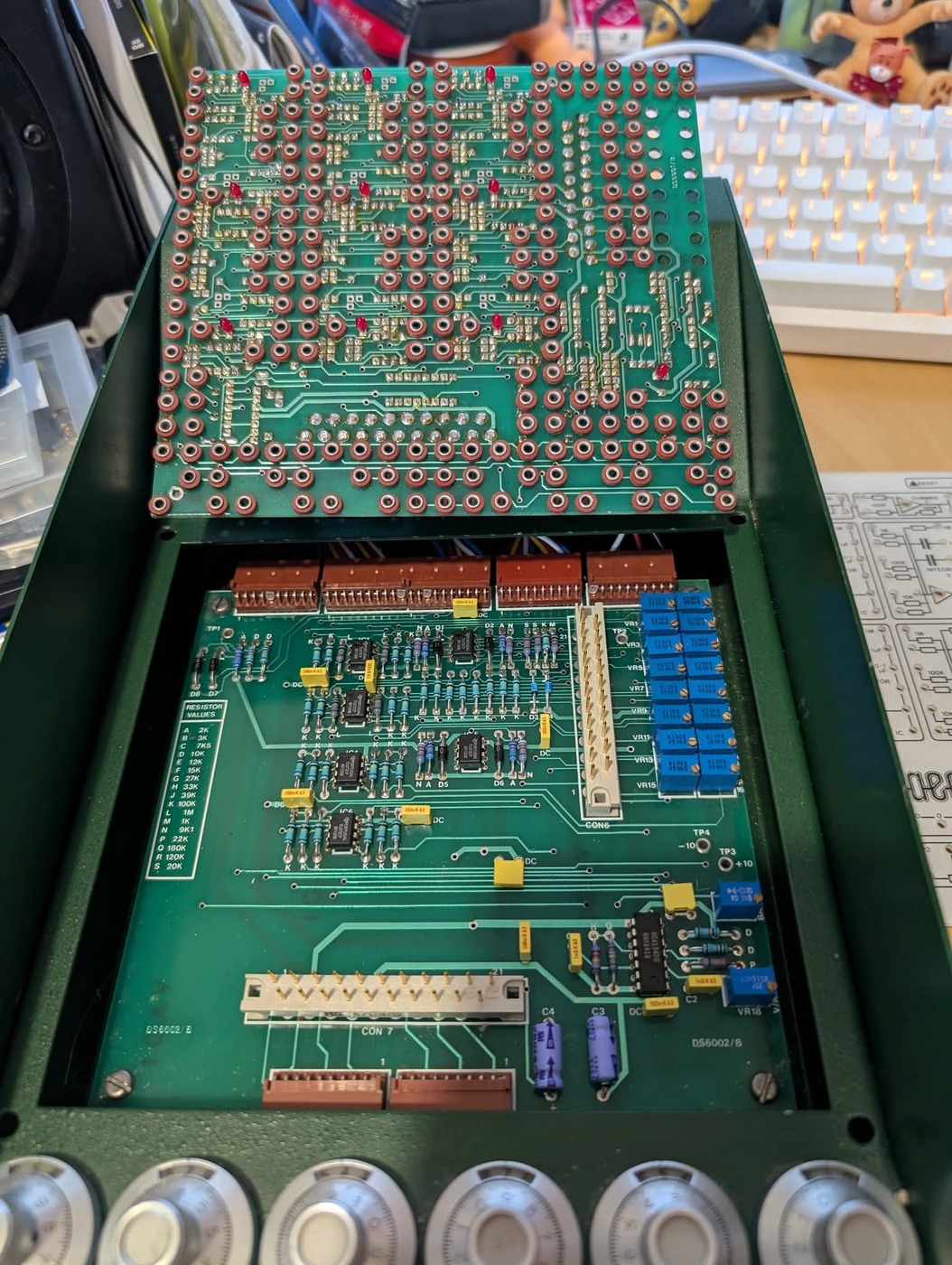 The lower board with the jack board lifted away, showing rows of axial resistors, TL072CP packages, the trimmer bank, test points and connectors.